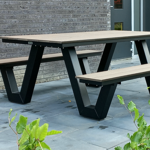 a black picnic table outside a building